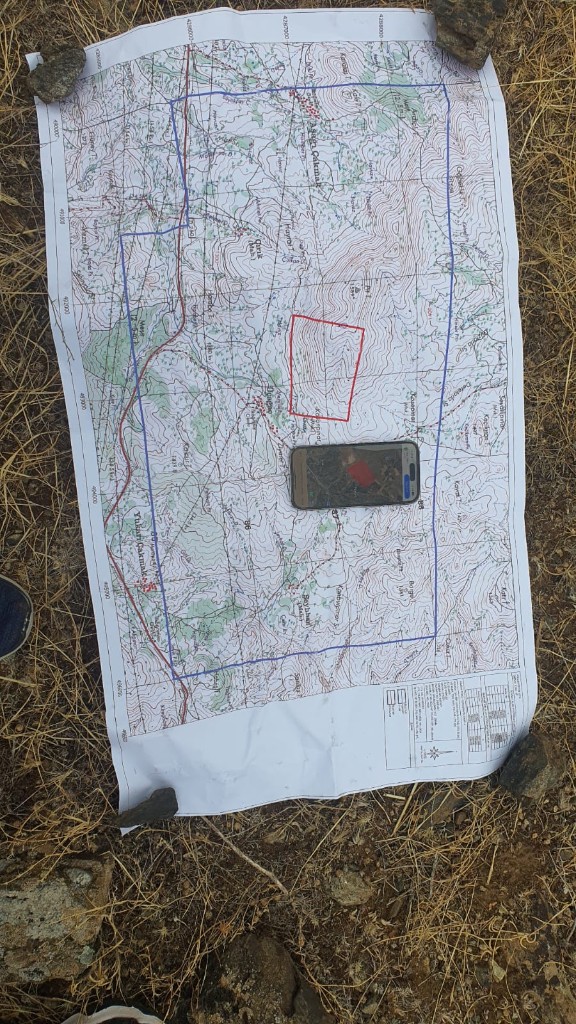 Topographic map and satellite check during high-altitude field survey