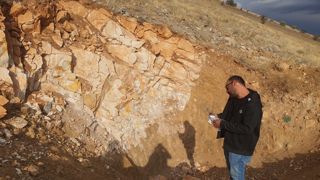 Geologist inspecting an excavated rock face at 2200 m above sea level